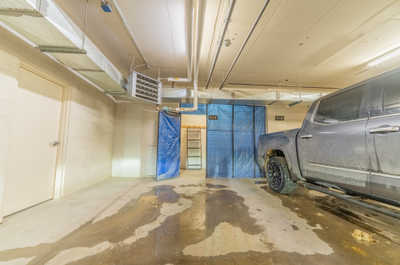 Underground parking space showing the unit number and storage space