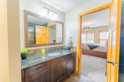 En-suite bathroom leading into adjacent bedroom
