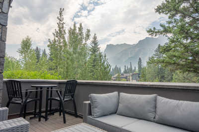 View from balcony showing mountains and trees in the distance