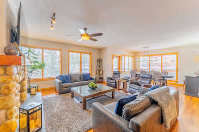 Living room with multiple seating areas and large windows