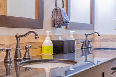 Bathroom sink with toiletries and towels
