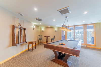 Shared recreation room with pool table and bar seating