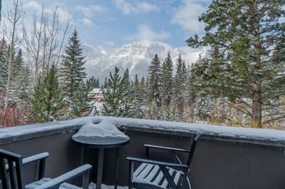 Snow-covered deck with distant mountain views