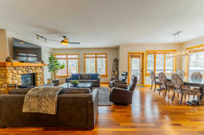 Living space with TV, stone fireplace, and dining area
