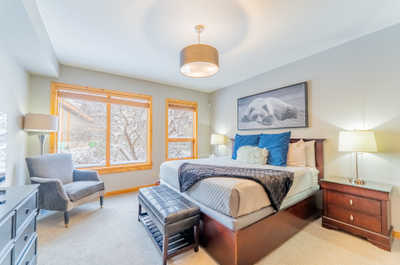 This bedroom has a seating area with armchair by the window