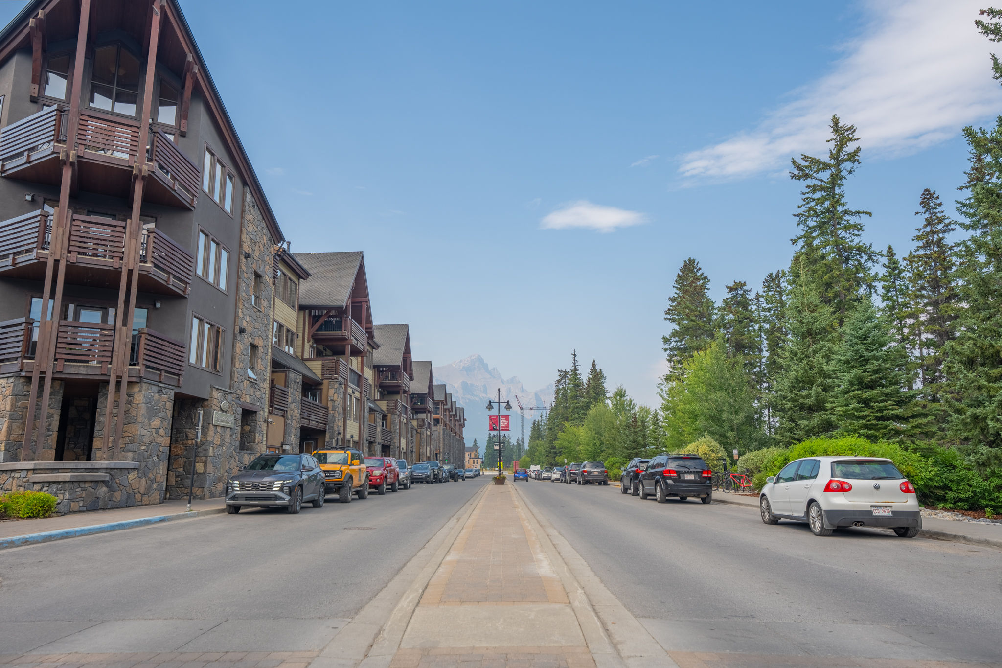 image Street view showing parked cars and buildings on both sides