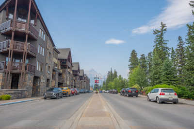 Street view showing parked cars and buildings on both sides