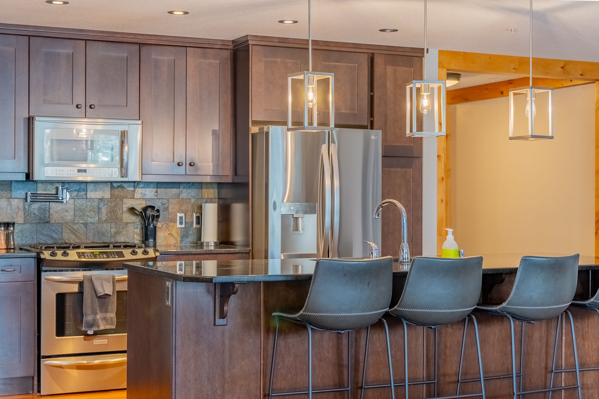 image Kitchen with stainless steel appliances and pendant lighting