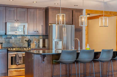 Kitchen with stainless steel appliances and pendant lighting