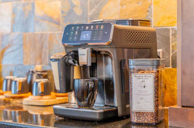 Coffee machine with a jar of coffee beans on display