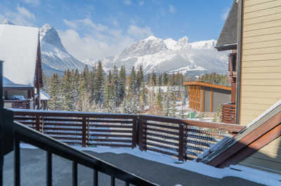 Mountain view from a balcony with snow-covered trees