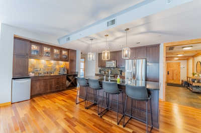 Kitchen with bar stools and pendant lighting