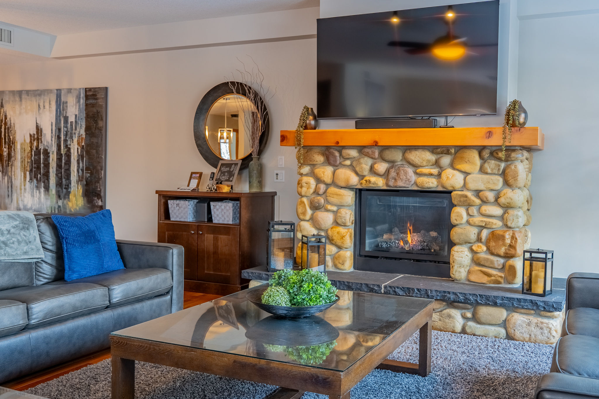 image Living room with fireplace, TV, and furniture