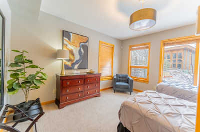 Bedroom with twin beds, dresser, and natural light