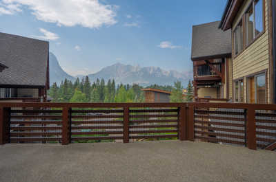 View from balcony with mountains and neighboring buildings