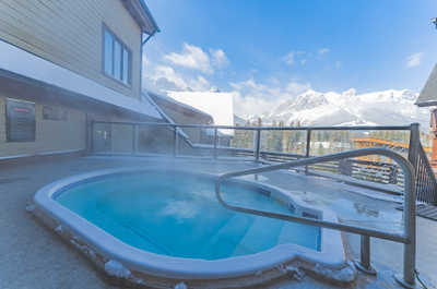 Outdoor hot tub with a snowy landscape in the background