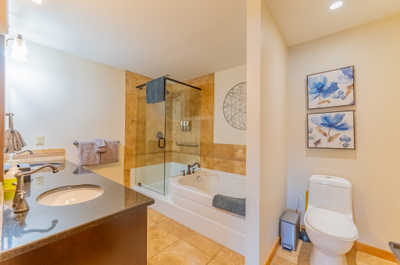 Bathroom with soaking tub and wall art