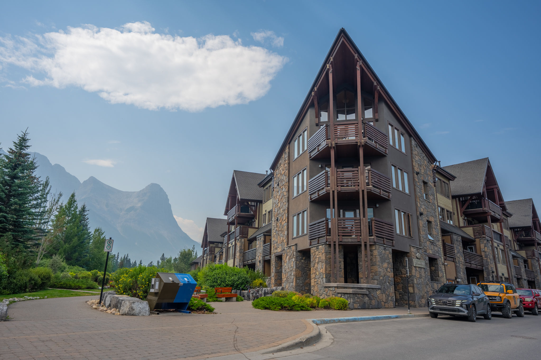 image Ground-level view of stone building with mountain backdrop