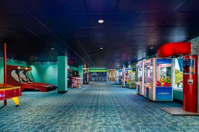 Explore a vibrant gaming area featuring diverse arcade games.