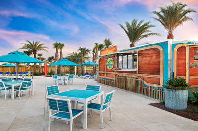 Enjoy your meals in a colorful outdoor setting with a tropical touch.