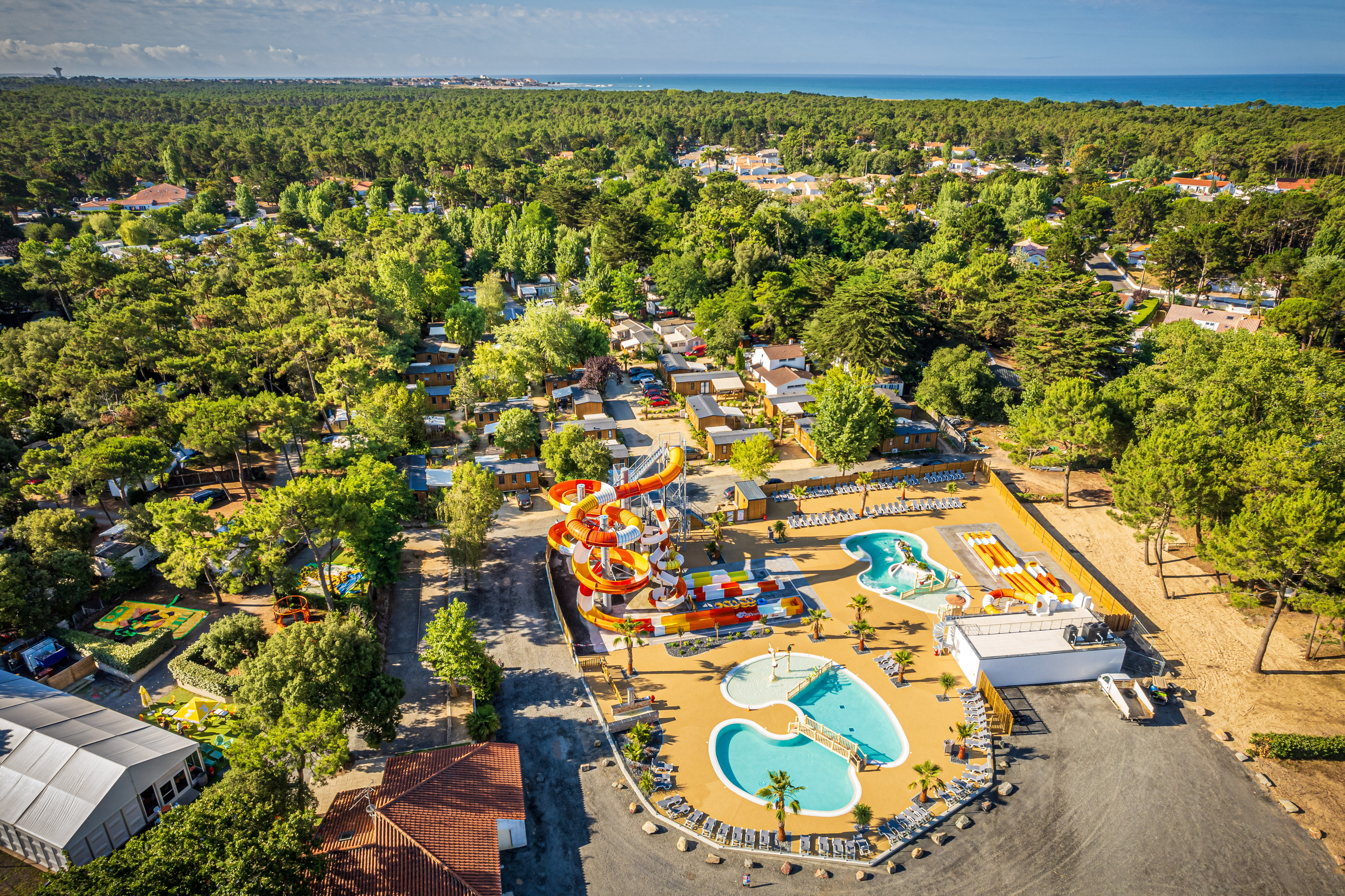 image Take in the beautiful aerial view of Riez à la Vie, where lush greenery meets the sparkling coast, making it an idyllic getaway for families seeking relaxation and fun.