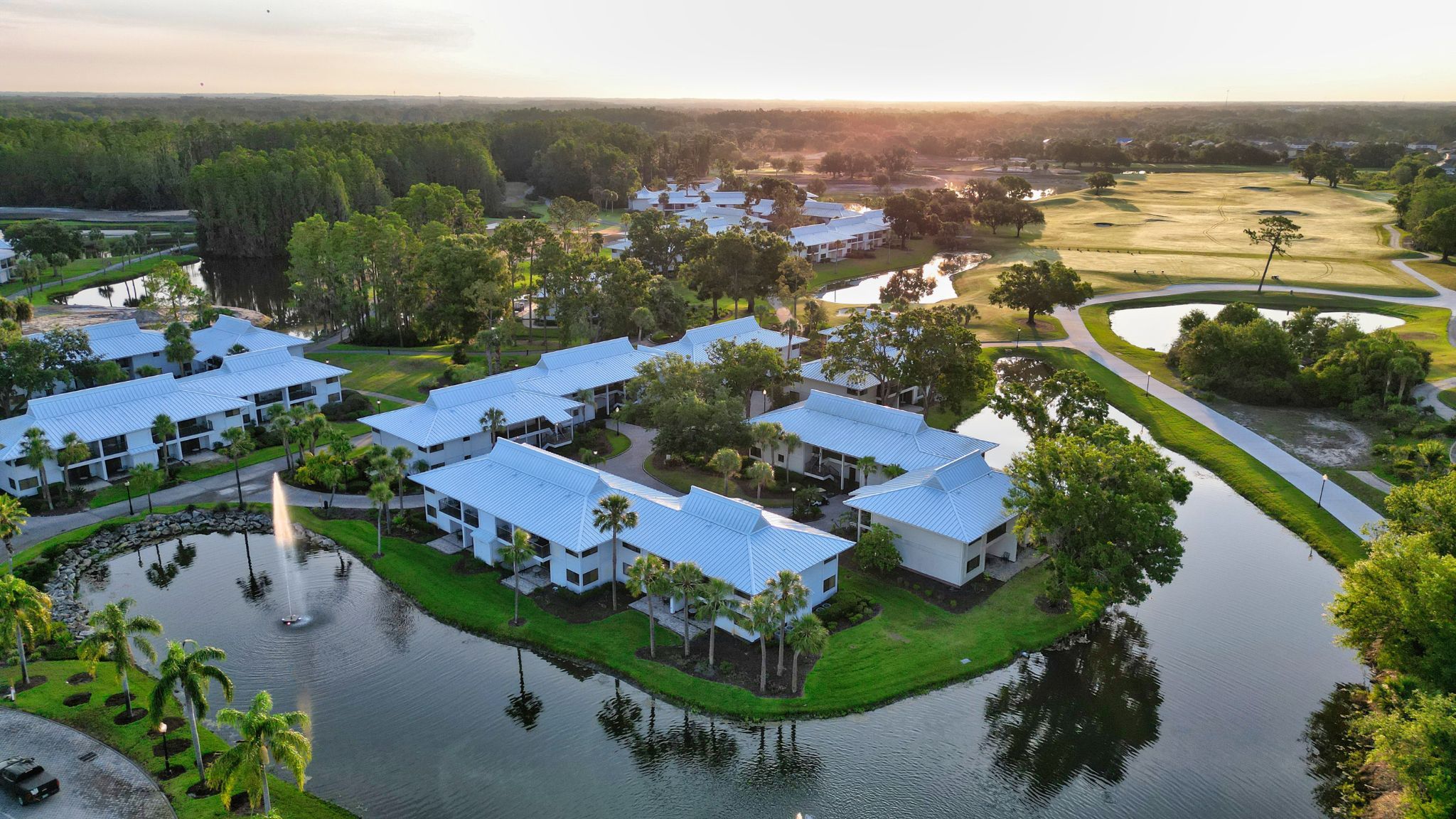 image An aerial view of serene lakeside lodgings framed by fairways and Florida sunshine.