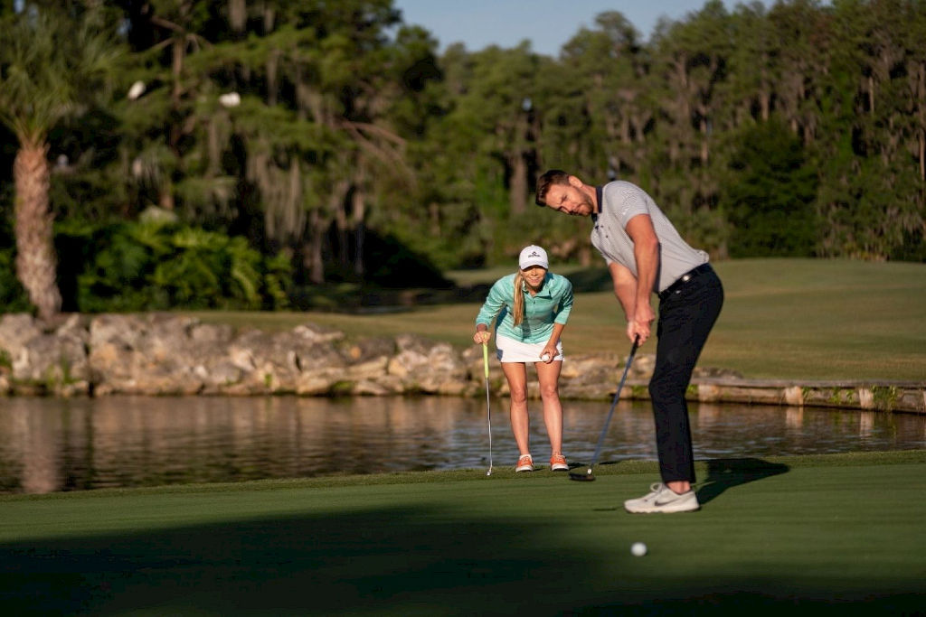 image Tee off into leisure on our pristine golf course, where every swing comes with a view.