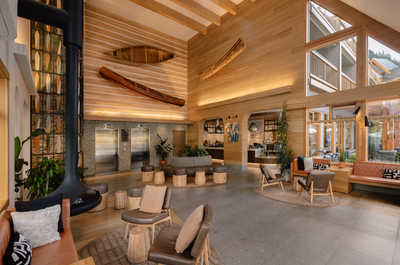 A bright and spacious lobby with natural wood accents and abundant light, creating a warm and inviting atmosphere for your stay.