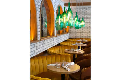 A cozy and intimate dining nook with warm lighting and comfortable seating, perfect for enjoying a relaxed meal.