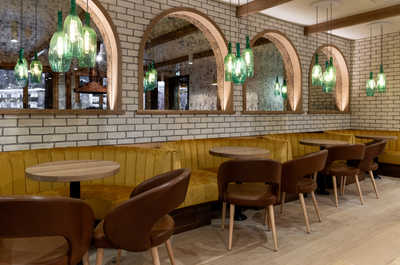A sophisticated dining area with arched brick accents and soft lighting, offering an intimate and refined dining experience.