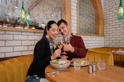 A delightful moment shared over a meal in a vibrant and welcoming dining setting, filled with laughter and warmth.