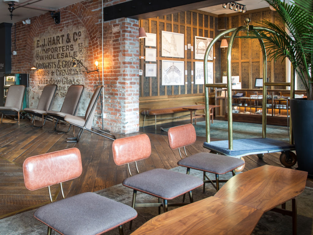 image Lobby with cozy seating nooks and exposed brick for a welcoming feel