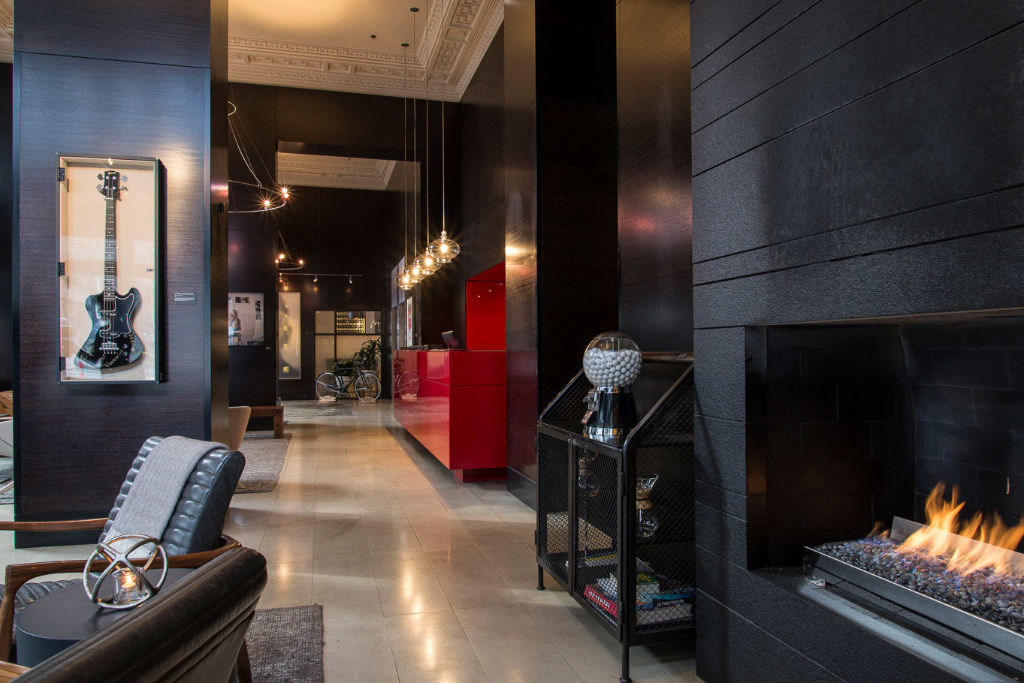 image Step into the warm embrace of Hotel Max's stylish lobby, complete with a welcoming fireplace.