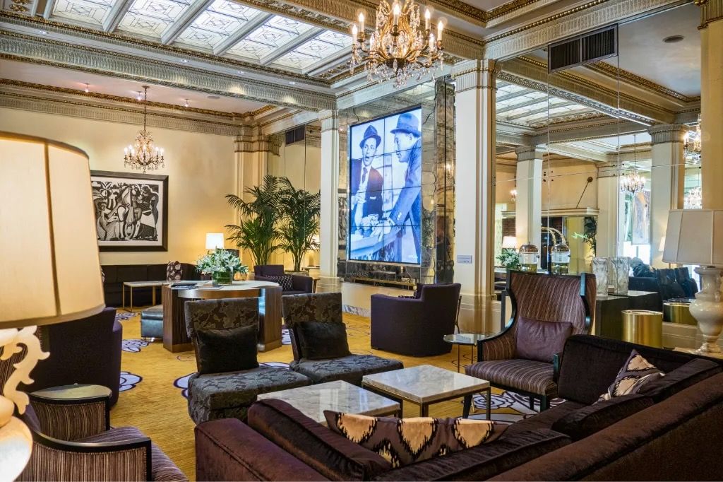 image Experience the grandeur of our hotel lobby, complete with plush seating areas and exquisite artistic touches.