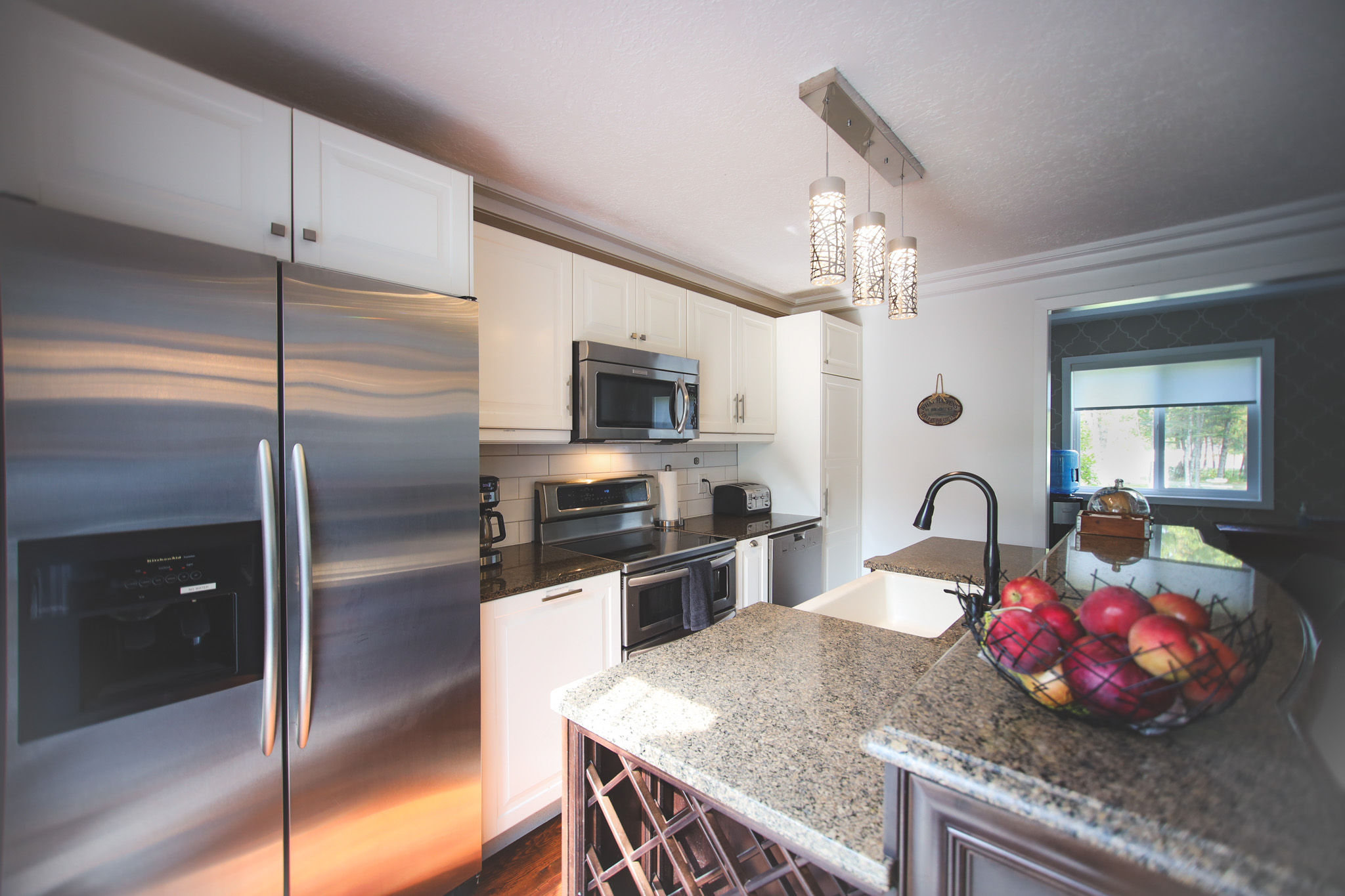image Cook in style in the fully equipped kitchen with stainless steel appliances, granite countertops, and a dining area.