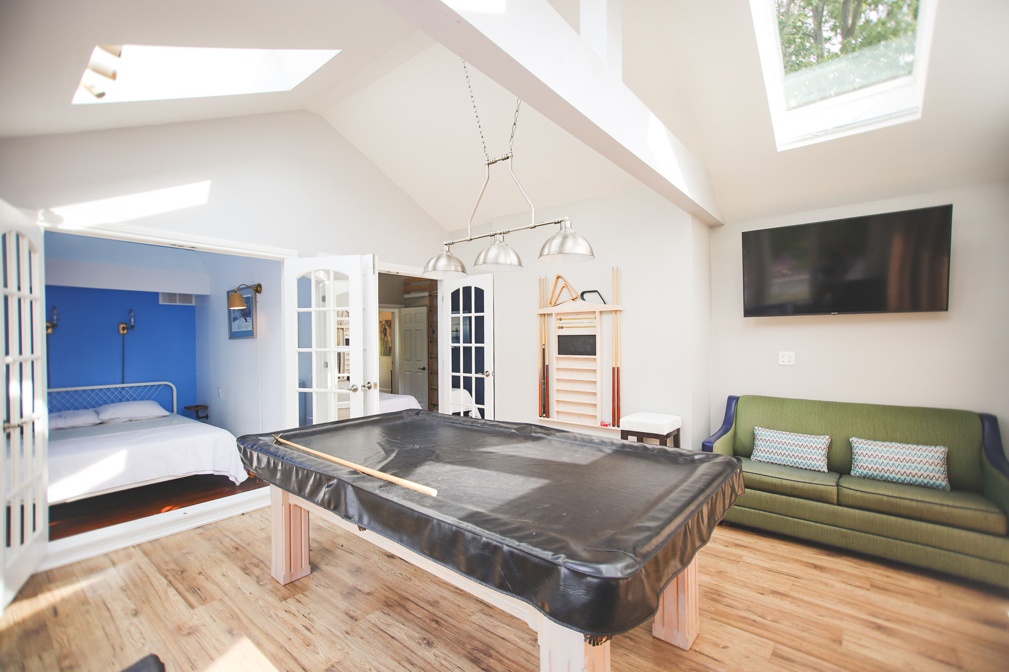 image Enjoy family fun in the games room featuring a pool table, flat screen TV, and additional seating.