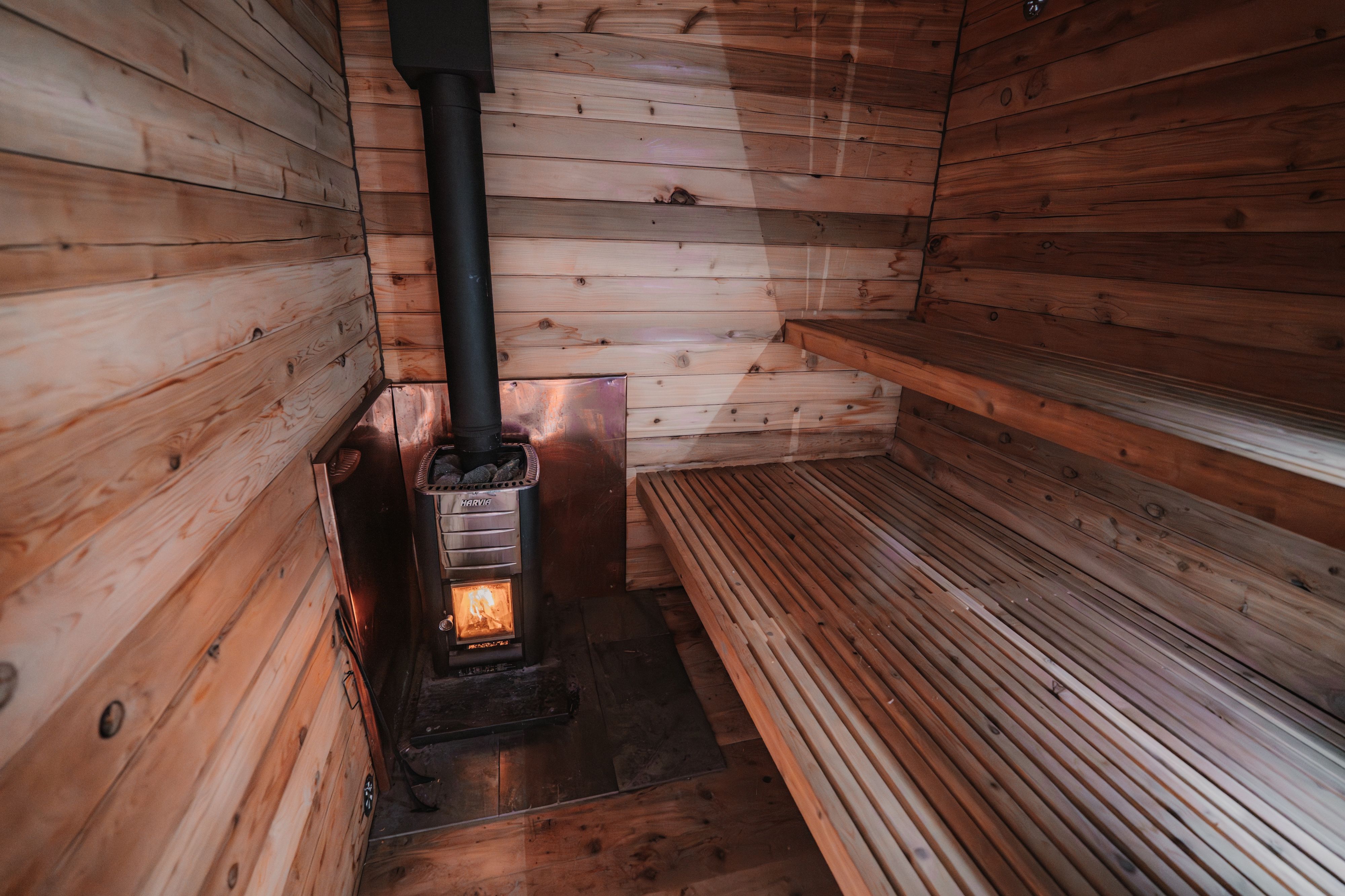 image Step into the warmth of the sauna, designed with natural wood for your relaxation.
