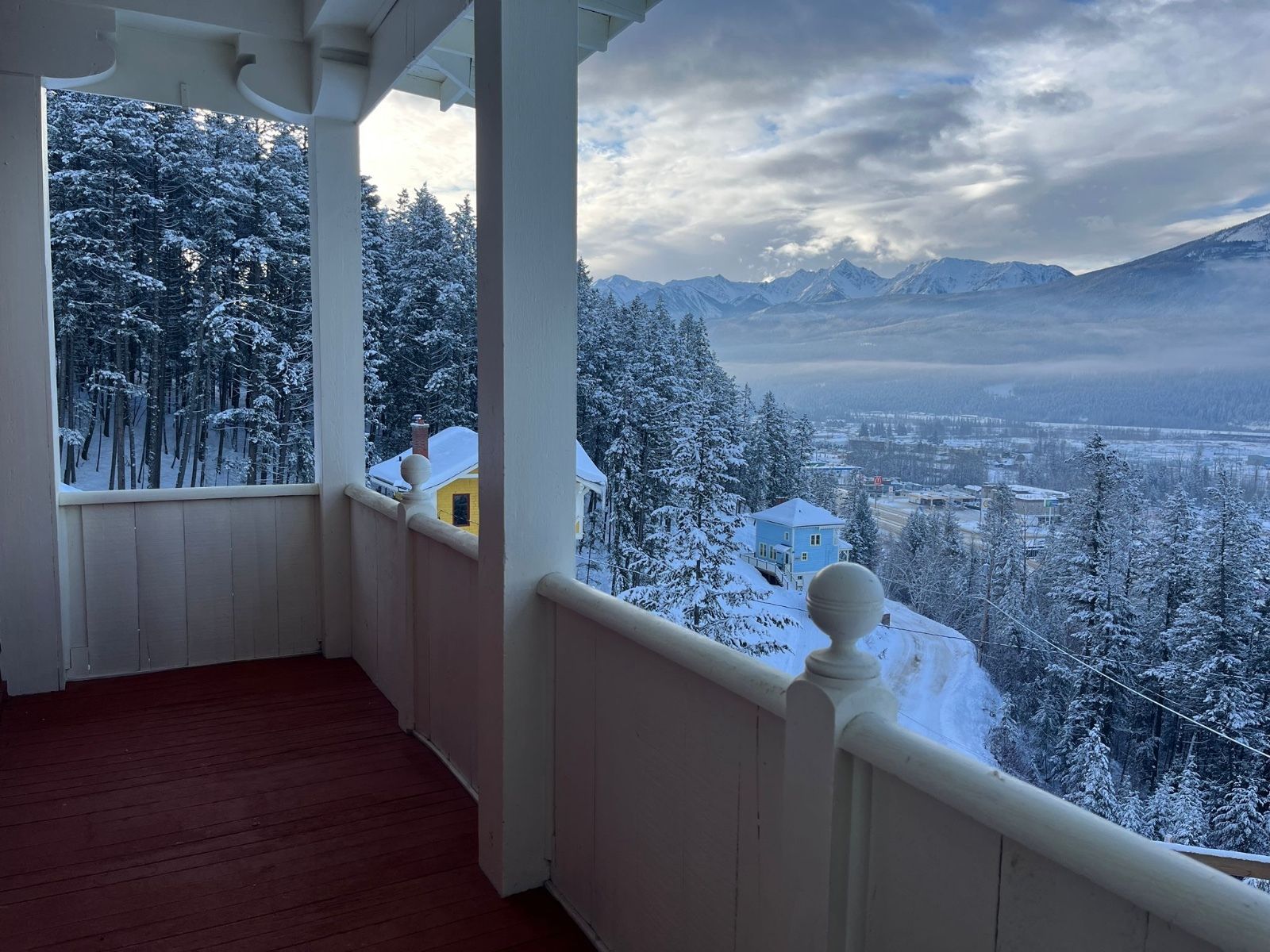 image Wake up to breathtaking mountain views from the comfort of a cozy, covered balcony, surrounded by serene snowy pines.