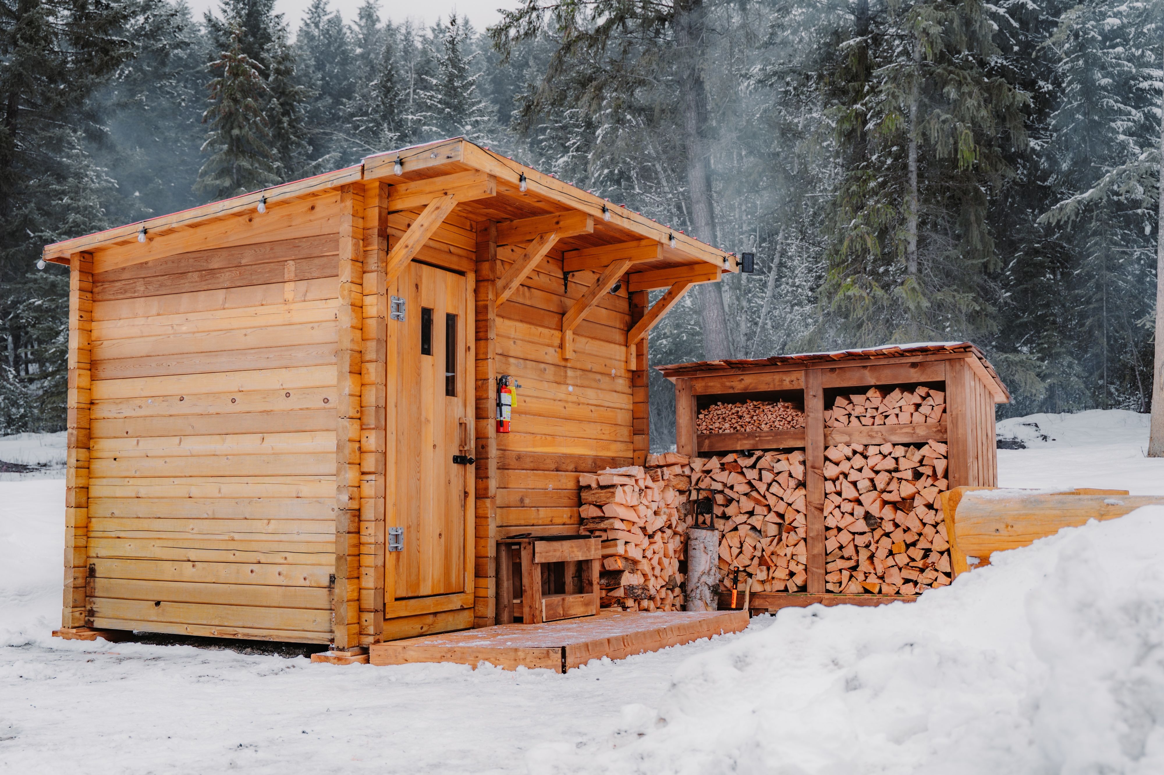 image Discover the charming wood storage beside your private sauna, enhancing your outdoor retreat.