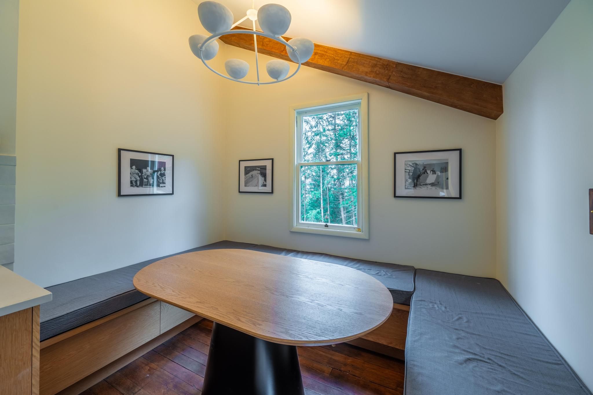 image Relax at the intimate dining nook, complete with soft cushions and charming artwork.