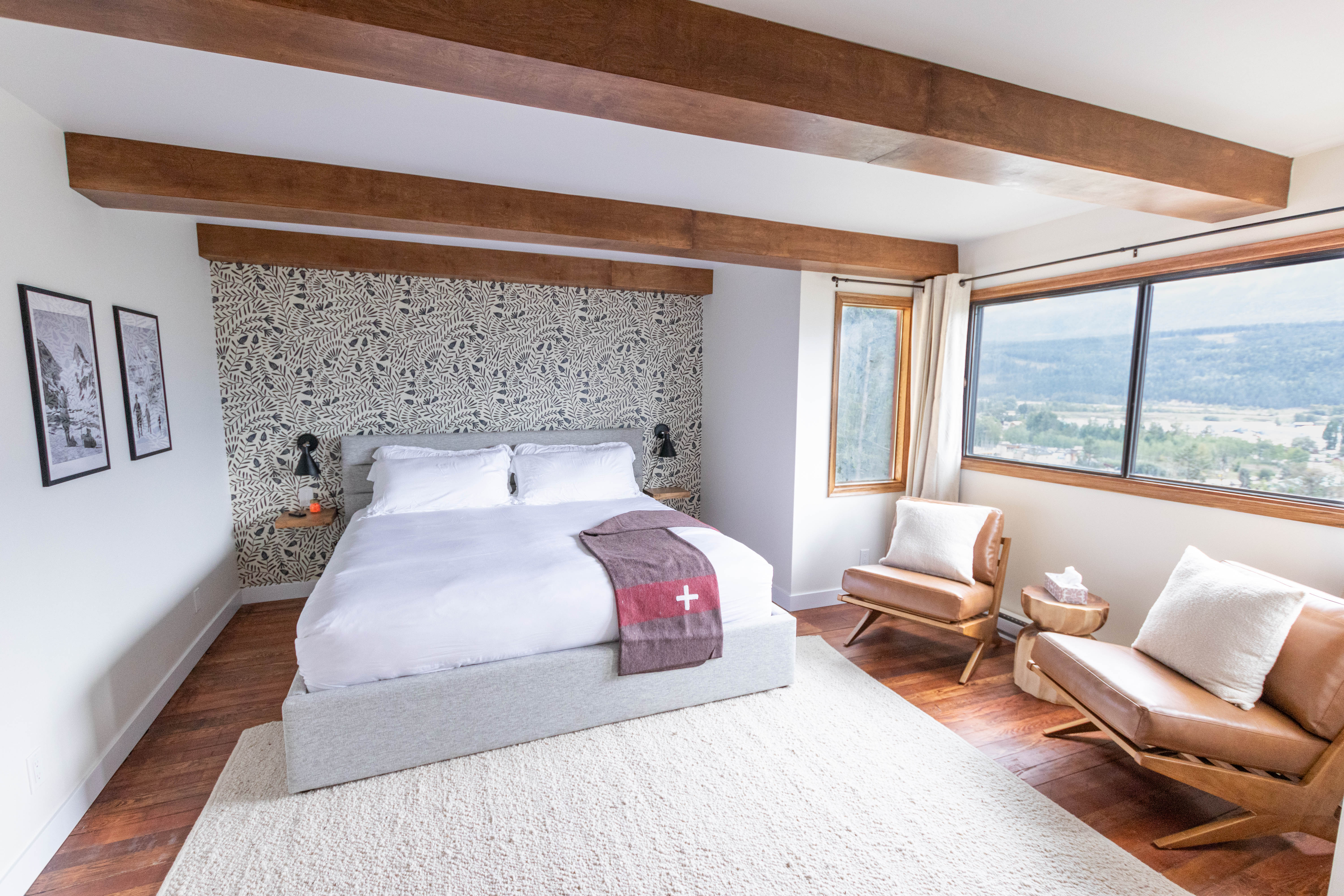 image Wake up to stunning mountain views from the comfort of this spacious bedroom, complete with a king bed and rustic charm.