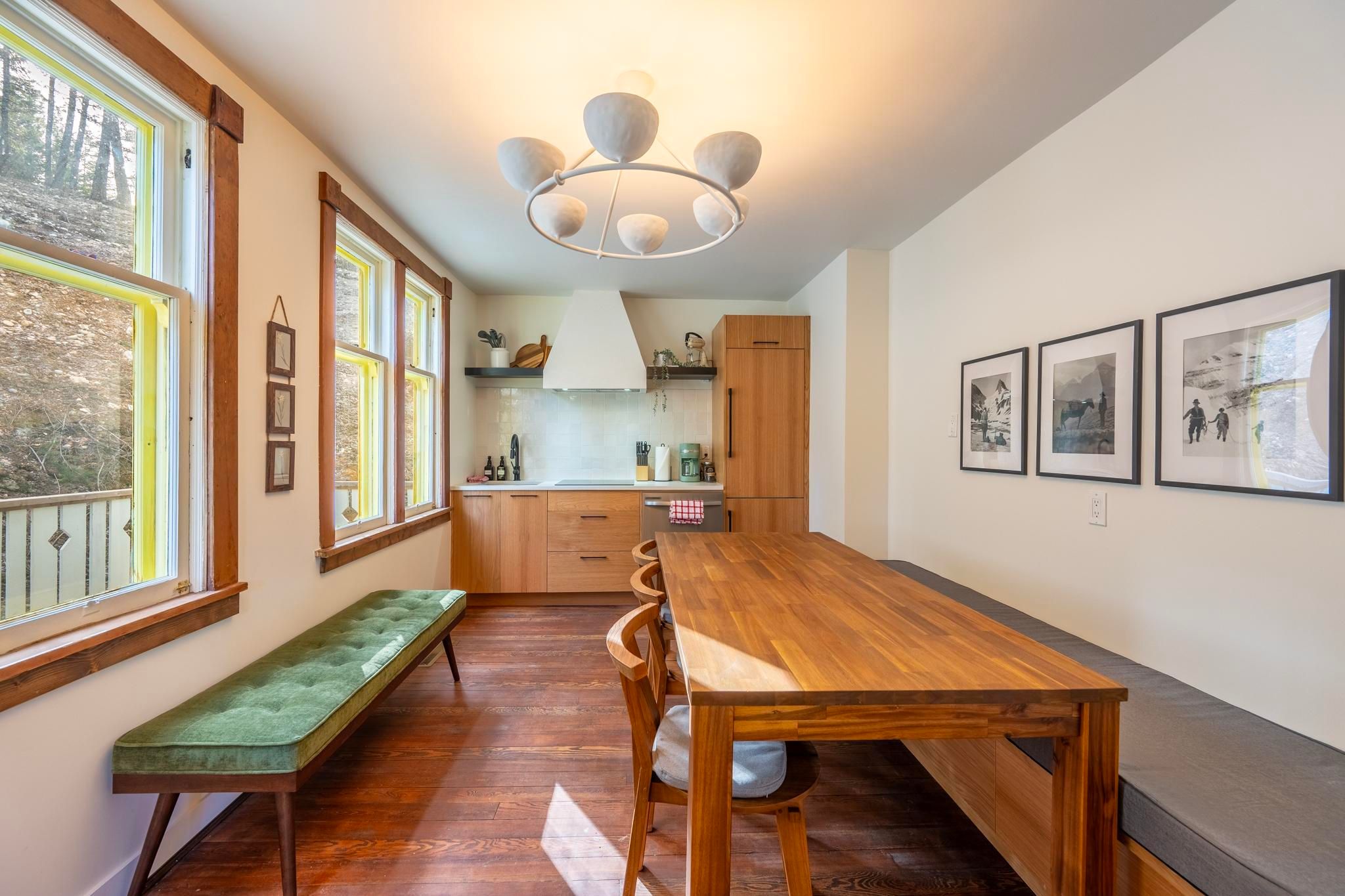 image Gather around a spacious dining table with natural wood finishes and natural light streaming in.