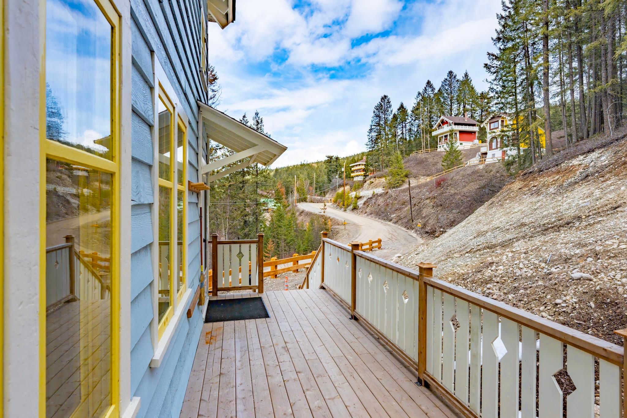 image Feel at home on the spacious deck, perfect for relaxing, with the forest gently swaying nearby.
