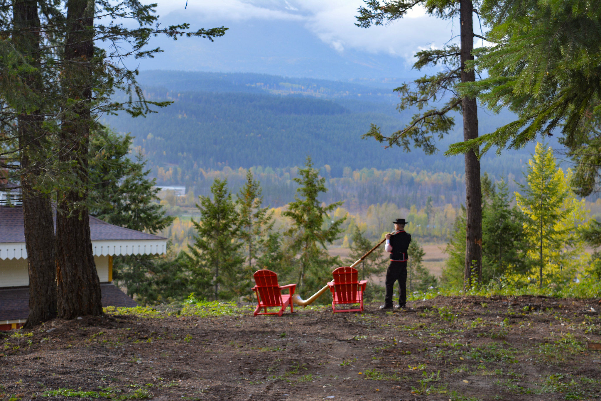 image Enjoy morning coffee in cozy red chairs, surrounded by lush trees and the crisp mountain air.