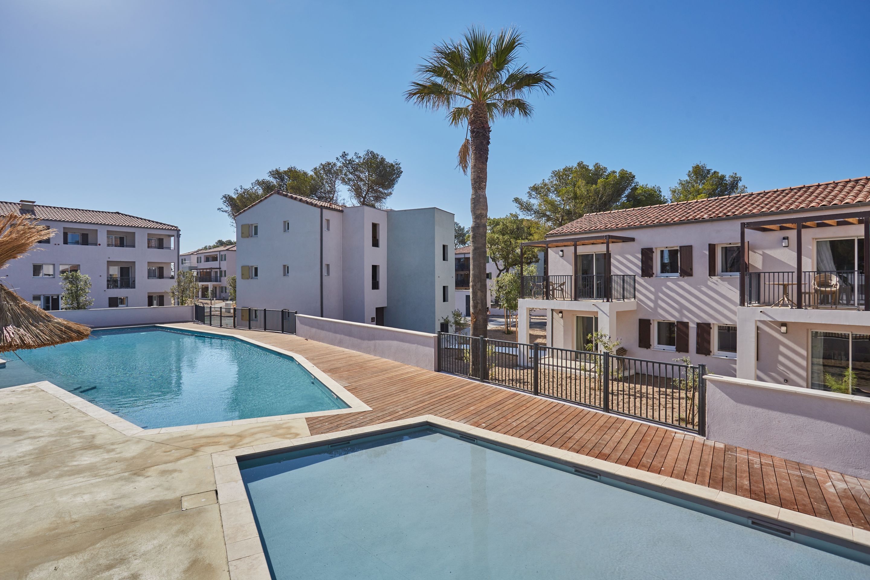 image This inviting pool area offers a serene escape for guests. Enjoy the sunny weather and the calm ambiance.