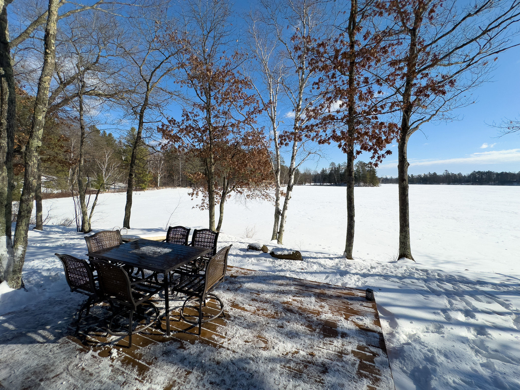 image Enjoy a meal by the lake at this scenic outdoor dining area. Whether summer or winter, the peaceful surroundings make every moment special.