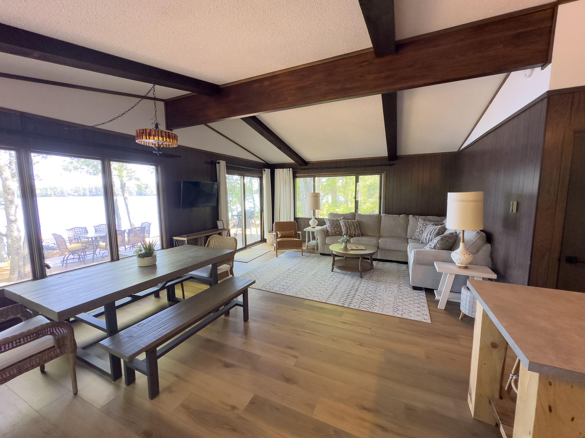 image The open-plan dining and living area offers plenty of space for meals and relaxation, with large windows that let in natural light and provide beautiful lake views.