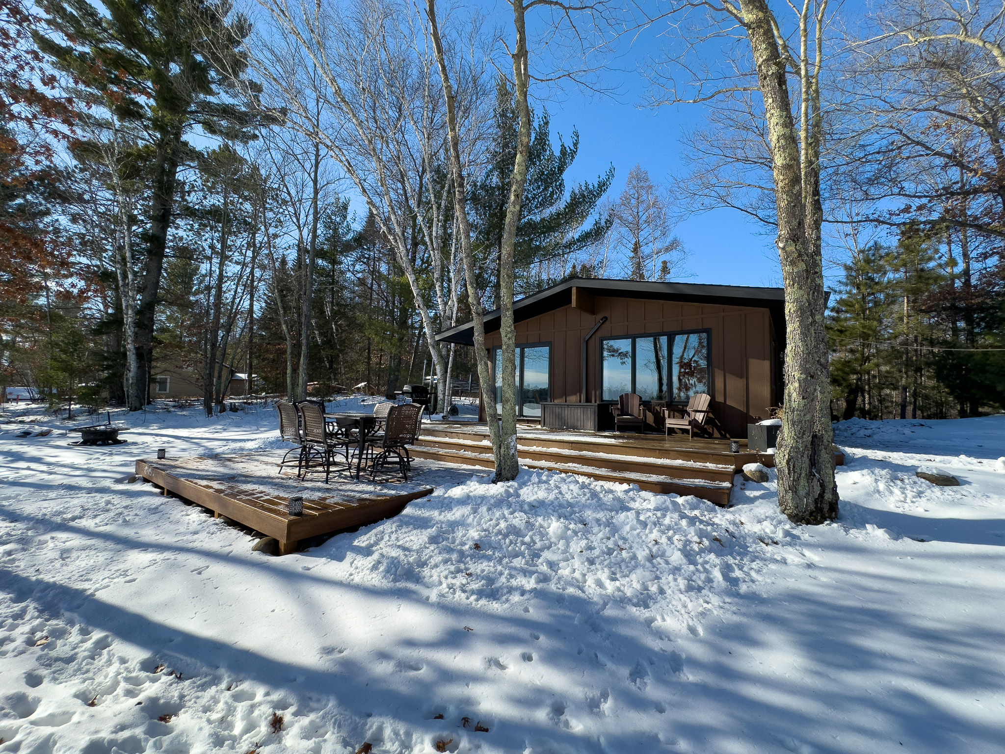 image Experience winter serenity at this cozy lakefront cabin. Enjoy scenic views, a spacious deck, and direct access to outdoor adventures, even in the snow!