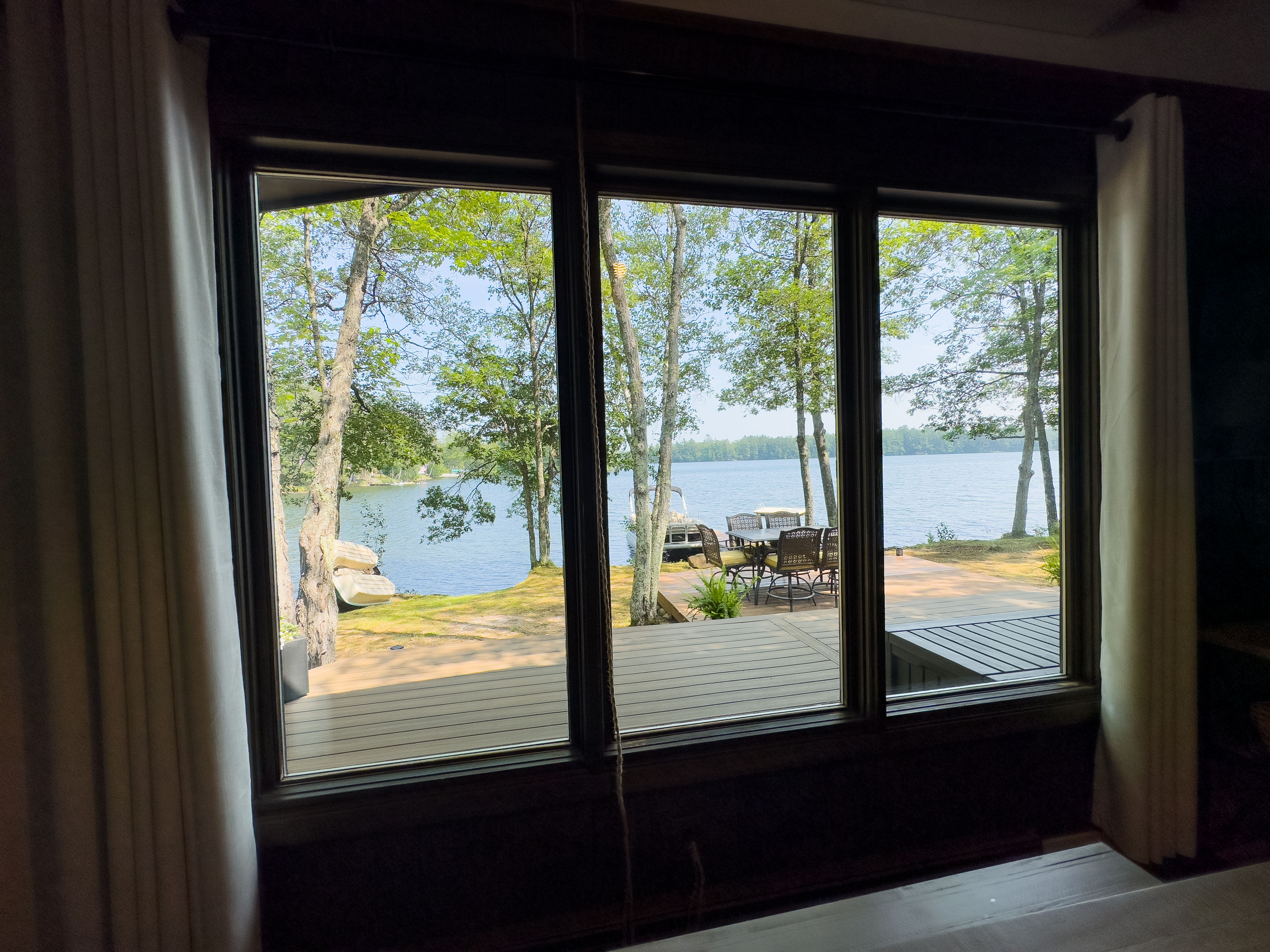 image Enjoy meals with a view at the dining table overlooking the serene lake, offering a perfect setting for memorable dining experiences.