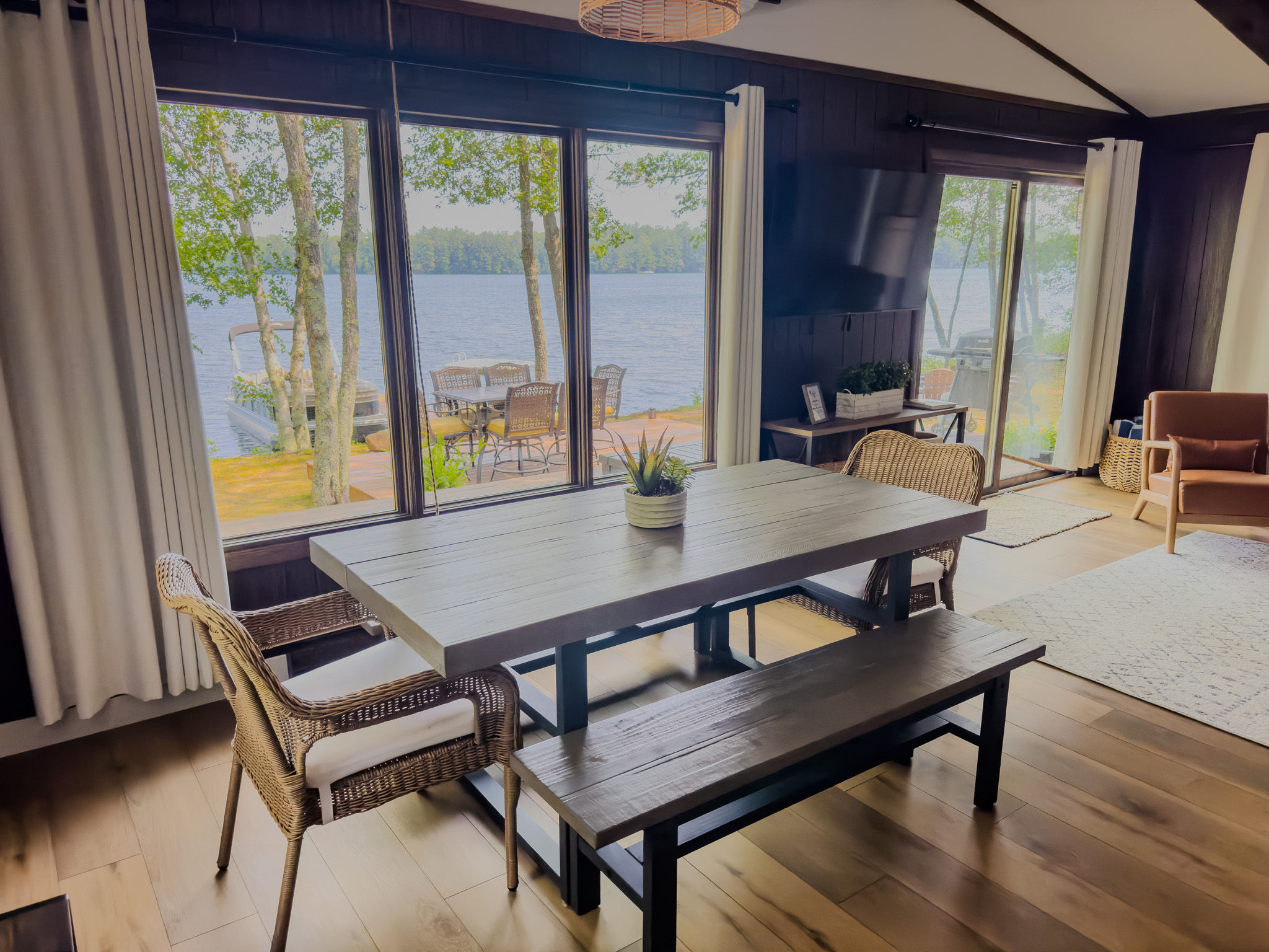 image Enjoy meals with a view at this lakeside dining area, where floor-to-ceiling windows frame breathtaking scenes of Twin Bear Lake.